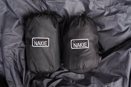 Studio shot showcasing Nakie's bug net and tarp, highlighting their durable construction and functionality for providing protection against insects and weather during outdoor activities