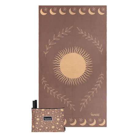 Brown recycled beach towel with cream sun, moons, stars, and leaf wreath design, shown with matching pouch.