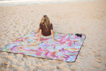 Recycled picnic blanket with vibrant multicolor swirl abstract pattern, displayed on beach sand. preview #6
