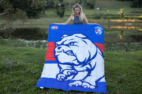 Western Bulldogs AFL puffy blanket in blue, red and white with bulldog logo, displayed outdoors