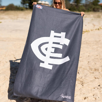 Carlton Blues navy beach towel with white logo and AFL badge, sand-free design displayed on beach