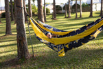 Person lying in a Nakie NRL Cowboys  patterned hammock between two trees on a grassy area. preview #5