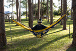 Back view of person sitting in a Nakie NRL Cowboys hammock between trees in a park preview #6