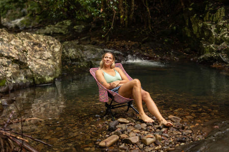 Rosy Tides Camping Chair at a rainforest creek