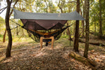 A man lounging in a Nakie hammock shielded by our Bug Net & Rain Tarp Combo, ensuring a peaceful outdoor experience away from insects and rain. preview #6